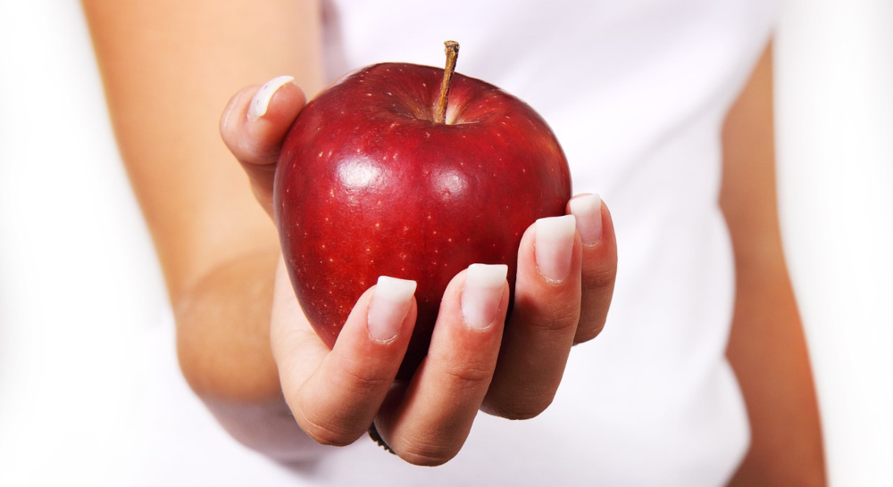 woman holding apple